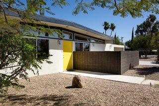 The home has a sunny yellow door that is picked up as a bright and fun accent color throughout. 