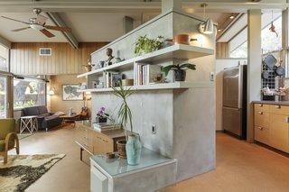 The divider keeps the open plan feeling a little less open, yet still allows the natural light to pour into the living space. 
