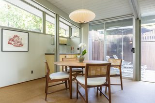 The dining area overlooks an outdoor patio. 