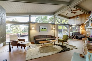 Tall tongue-and-groove ceilings are supported by an exposed post-and-beam construction, with clerestory windows on both sides.