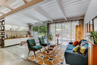 The soaring tongue-and-groove ceiling adds to the authentic midcentury charm. 