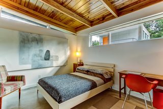 The bedrooms feature original exposed wood ceilings and clerestory windows for additional natural lighting. 