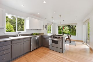 The adjacent dining nook features sliding doors that lead out to the patio and a breakfast bar. 