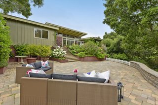 Stairs lead to the garden's lower level and a larger patio that is an ideal setting for entertaining.