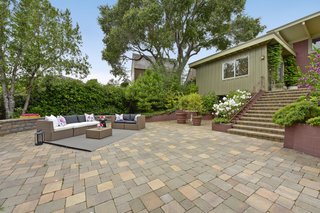 The landscaping has been given lots of love and includes Japanese maples, palm fronds, drought-tolerant grasses, and flowers. 