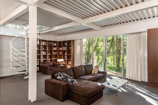A spiral staircase leads to the lower-level living room. 