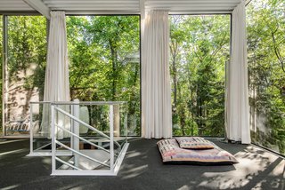 The exterior walls above grade have been completely glazed with the original bronze tinted glass, and are secured directly to the structure by neoprene zipper gaskets. 