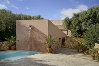 Amenities include a pool with a waterfall and a sunken tennis court. 