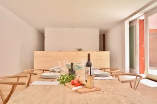 The kitchen and the adjoining dining area sit nearby the poolside terrace. 