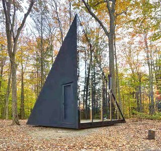 The triangular floor-to-ceiling window, which features seven glass pieces, allows natural daylight to illuminate the interiors. 