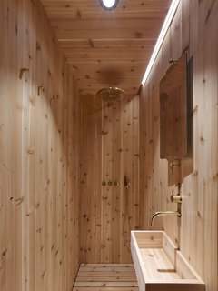 The sauna-like bathroom is made of cedar and features fixtures from VOLA.