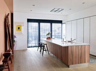 The streamline design of the kitchen is practically camouflaged into the design of the home. 