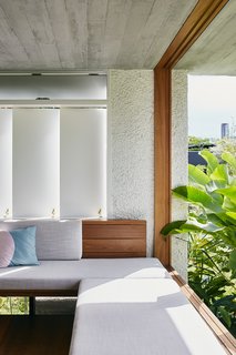 The minimalist material palette is a mix of whitewashed stucco, wood, and concrete. 