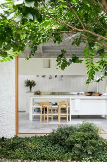 When tapped to redesign a darling cottage in Brisbane's Little Italy, the team at Cavill Architects was inspired by "architecture with veneration for the past." As a result, the newly remodeled dwelling now pays homage to the Italian migrant workers' housing that was a crucial part of the Australian city's post-war settlement. The notion of an integrated indoor/outdoor experience runs counter to the plan of a traditional Queensland worker's cottage, where the living areas often sit alongside an external deck. 