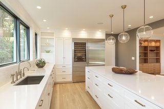 Instead of using marble for the countertops, Silver chose Pental Quartz, a more durable and practical material. He also has incorporated marble in the backsplash tiles. 