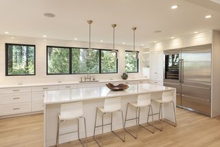 Bright and spacious, the top-of-the-line chef's kitchen is full of high-end touches. The sub-zero refrigerator even includes integrated wine storage with a shelf for a cigar humidor.