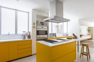 Bright yellow cabinets in the kitchen add a playful, fun touch, while also maintaining to same sleek, contemporary look. 