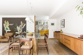 The dining area leads to the kitchen which sits behind a grand wooden pocket-door, allowing the space to be closed off as needed. 
