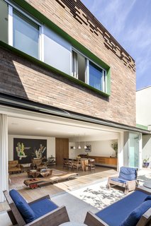 Through the bright front door, a hallway leads to a spacious living and dining room, which opens to a garden. 