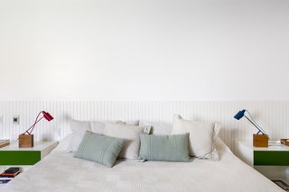 The serene shade of green is echoed in the furniture throughout the home, including the bedroom nightstands. 