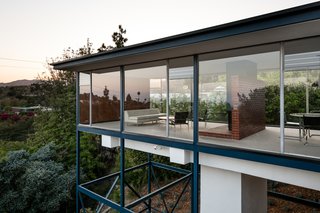 "At night, the Smith House appears to float like a glass box in space."