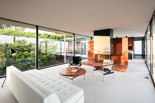 A look at the open living plan. Note the fireplace is set in the center of the space against a brick dividing wall. 