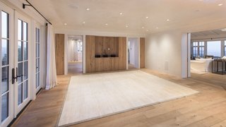In the main residence, the interiors are bright and airy, and house wide-plank oak floors and Venetian plaster walls, which add to the sophisticated, yet rustic feel of the home. Oversized French doors foster a seamless indoor-outdoor flow to a trellis-shaded dining terrace.