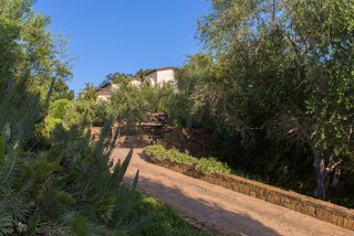 The primary residence is a three-bedroom, three-bath, French-inspired villa, which overlooks a resort-style pool and spa. The home is surrounded by mature shade trees, as well as a series of meandering, stone-paved walking paths. 