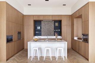 The kitchen now sits comfortably between a dining area, a large reading room, and an informal space for the kids. 