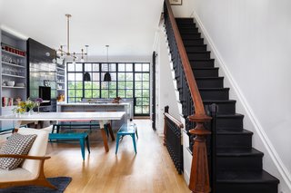 The parlor floor features an open floor plan that maximizes the interplay of light and space. A wall of casement windows frames the area, drenching the entire floor with warm natural light. 