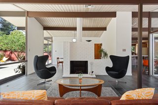 The post-and-beam ceiling is highlighted with pendant globe lights.