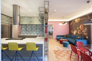A colorful sitting area adjacent to the kitchen features an additional dining area. 
