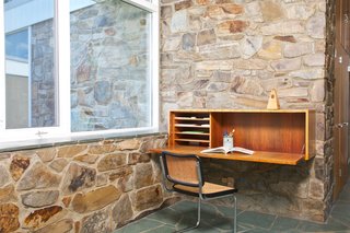 A built-in desk with a Breuer-designed chair sits in a corner of the den.