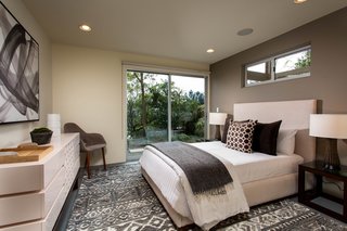 The home features four bedrooms, all with en-suite baths. Three of the suites are located on the lower level. 