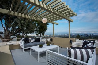 A rooftop deck is perched privately above the neighborhood and features stunning city views. 