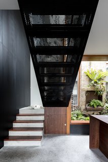 Perforated black metal has also been used in the design of the staircase. 