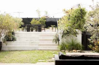 The addition of black metal perforated screens along the perimeter of the garden provide privacy and light, without appearing to be too austere.