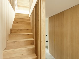 The material palette of oak, birch plywood, and oiled pine—combined with the polished concrete floor—add a textural richness to the space. 