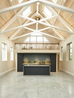 After a thoughtful restoration, a former chapel embraces a new calling as a vibrant, contemporary space for a local artist. The renovation features a pulpit-like mezzanine that overlooks the main living area. This new cantilevered structure creates a focused central nucleus for the home. Containing the kitchen, office, library, and plant room, much of the interiors can be seen from the mezzanine, a place to foster the owner’s life and work. A birch plywood skin wraps the mezzanine structure. 