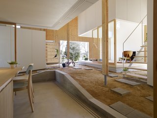 In reimagining the traditional Japanese doma for contemporary living, the architects have retained the site's original topography and integrated the sloped terrain into the design of the home.