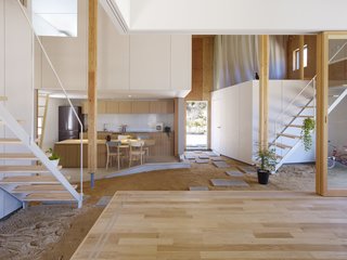 "The doma is not only a corridor, but also a place to put shoes and hang paintings," explain the architects. "It is a like an outdoor space, but it is internal."
