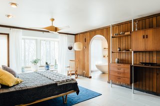 An arched doorway leads to an ensuite master bath. 
