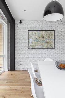 White walls serve as a gallery to display the owner's personal art collection. 