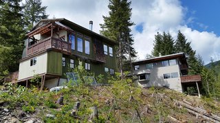 A look at the original 1970s cabin as viewed from the lower east portion of the property. Much work was needed to tidy up the hillside site. 