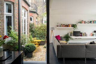 On the other side of the sitting room is a small courtyard, framed by internal glazing and accessed via a glazed side-door. 