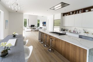 A bright modern kitchen was added to meet the specifications of a family that loves to cook. A large pantry was added to help keep the kitchen clutter-free. 
