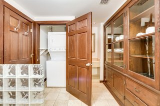 The bathroom conceals the washer/dryer, and also benefits from original cabinetry. 