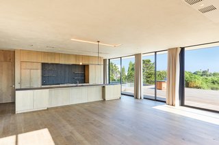 The expansive open-plan living and dining layout is complemented by a meticulously appointed chef's kitchen.