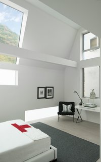  The guest-bedroom suite frames the hillside views above the street, increasing natural light and maintaining privacy.