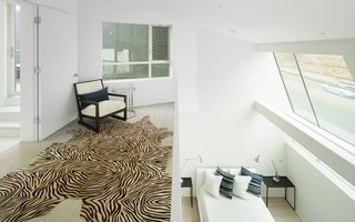The large stairwell connects all of the levels and allows for cross ventilation throughout the home. The passive ventilation strategies take advantage of the location’s climate. 